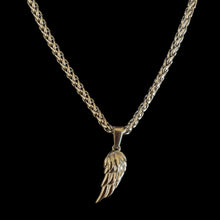 Silver wing pendant necklace on a braided chain, perfect for adding a stylish touch to any outfit.