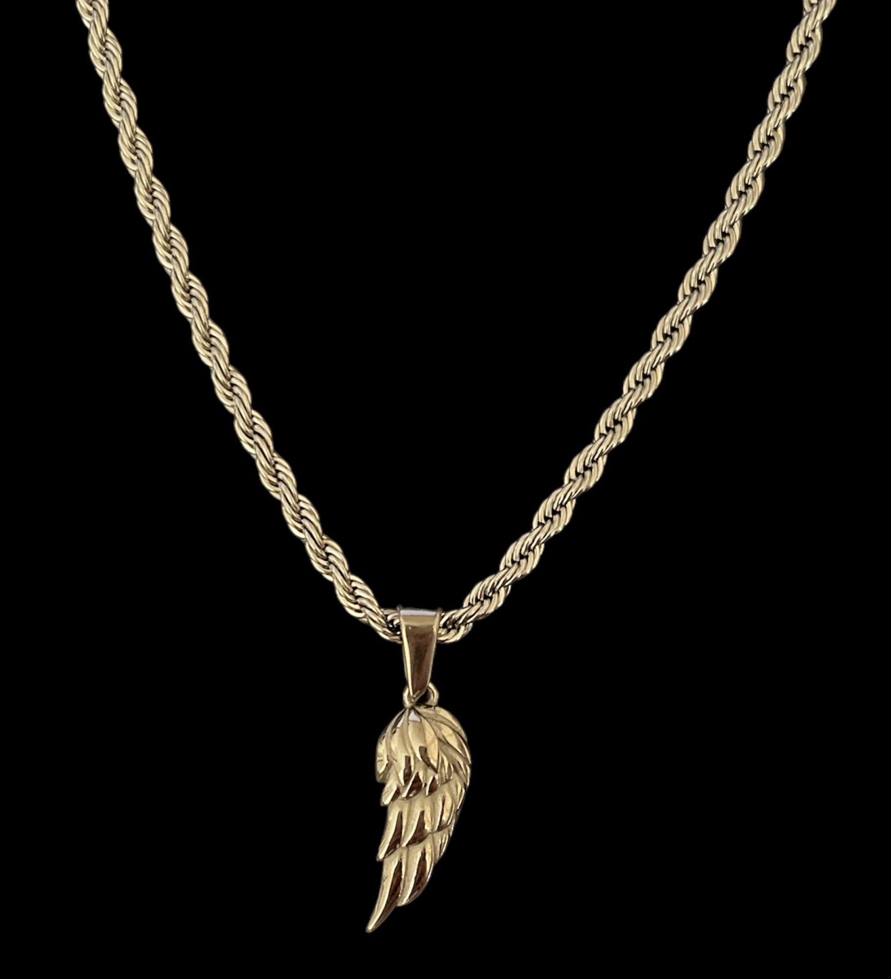 Golden wing pendant necklace on a twisted chain, perfect for adding elegance and style to any outfit.