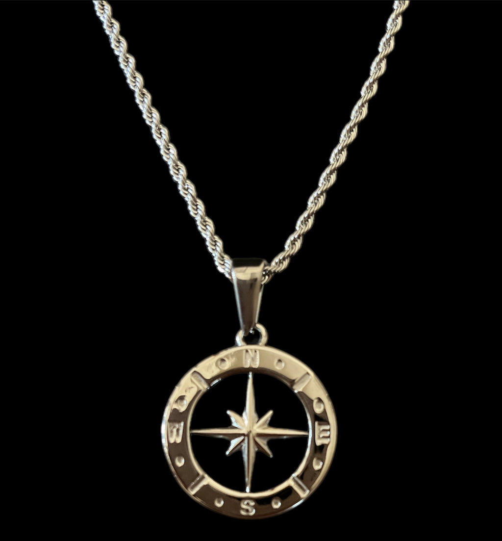 Silver compass pendant necklace on twisted chain, symbolizing direction and adventure in stylish jewelry.